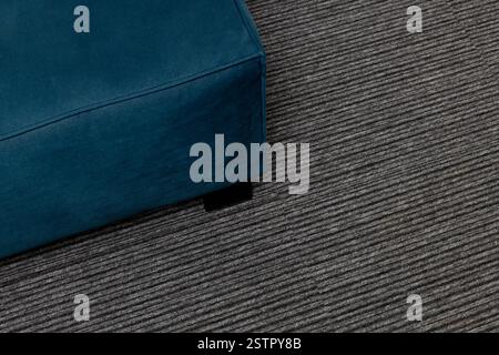 Close Up Top View of Dark Blue Sofa on Gray Carpet Stock Photo
