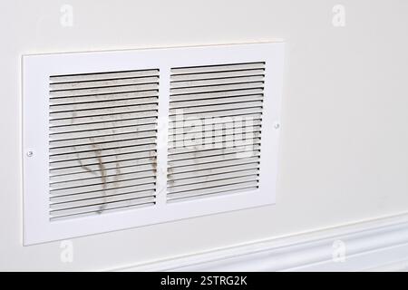 Dirty dusty return vent cover on a house wall with copy space Stock Photo
