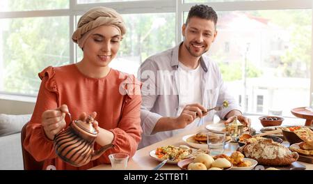 Muslim couple having dinner together. Ramadan celebration Stock Photo