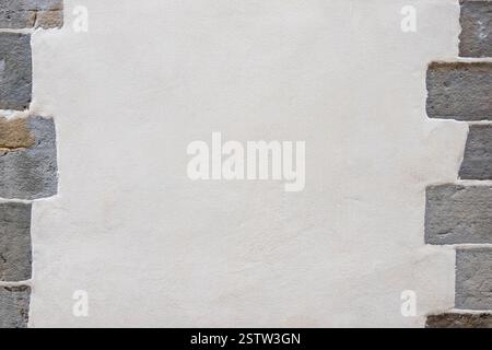 Plastered wall with stones on the sides Stock Photo