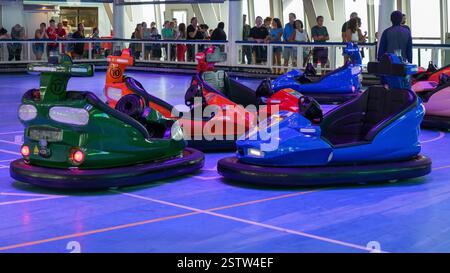 People having fun and bumping into each other with electric bumper cars on a cruise ship. New York NY USA - 09.02.2024. Stock Photo