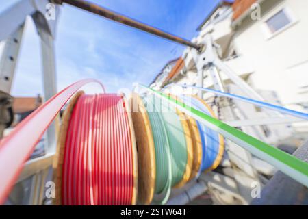 Cable drums with coloured cables in a technical plant, Wend Glasfasermontage during the jetting of conduits for fibre optic cables, Messkirch, distric Stock Photo