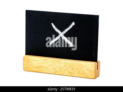Blackboard with "X" Symbol: A close-up shot of a miniature blackboard, with a crisp white "X" marked on its surface. Stock Photo