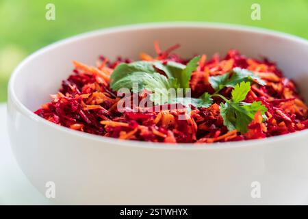 Beet and carrot salad in a white salad bowl Stock Photo