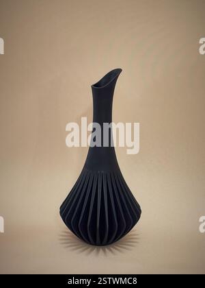 Black Art object flower vase home decor printed on 3D model printer from melted plastic. progressive technology 3D printing recycling Stock Photo