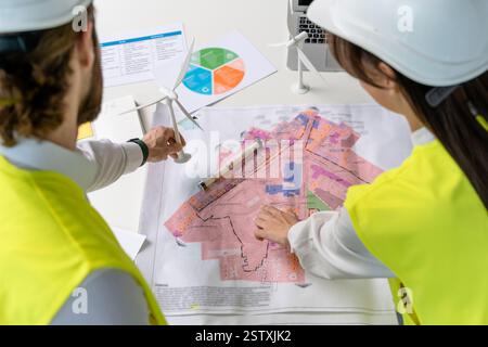 Two engineers looking busy while discussing new project details Stock Photo