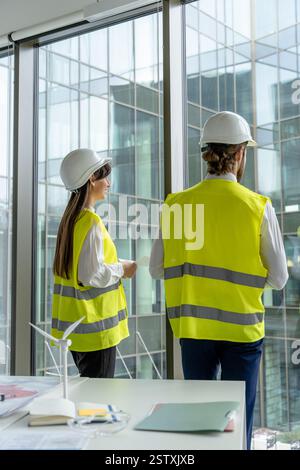 Two engineers working in the office on a new green energy project Stock Photo