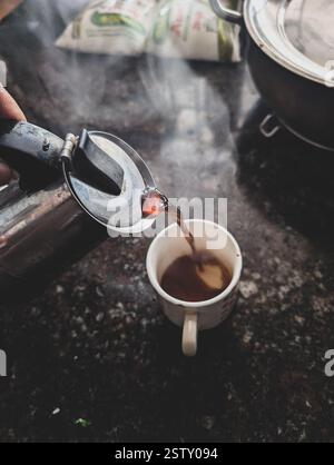 Pouring a hot shot of morning South Indian filter coffee from a moka pot in an Indian household. A perfect start to the day with aromatic, rich flavor Stock Photo