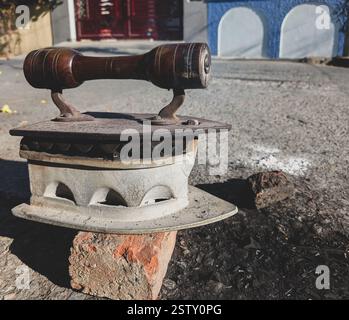 A vintage hot iron press for clothes used by Indian professional dryers and local washermen called Dhobis. Stock Photo