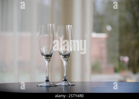 Two empty glasses of Champagne on table after party Stock Photo