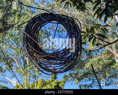 An optical fiber orange network cable running across the sidewalk on Rajpur Road, Dehradun, India. Stock Photo