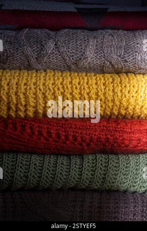 Stack of folded colorful cozy woolen knitted sweaters closeup Stock Photo
