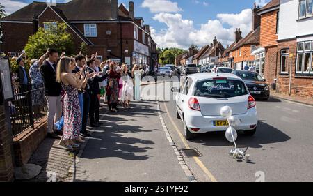 Car carrying the bride and groom to the wedding venue in a specially decorated car. Stock Photo