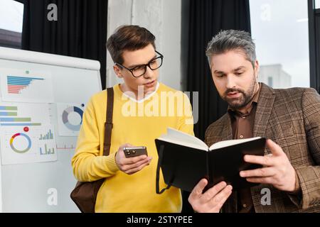 Colleagues engage in onboarding discussions while reviewing important documents in an office. Stock Photo