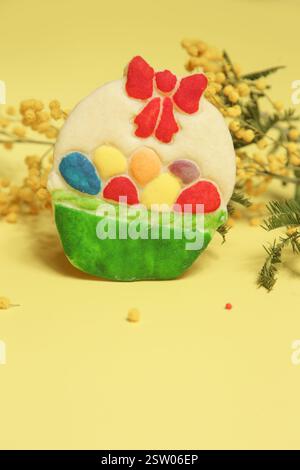 Sweet and buttery handmade sugar cookie, Cute homemade Easter basket biscuit with on the  spring yellow background Stock Photo