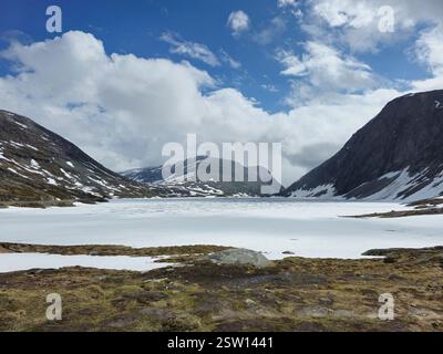 Majestic Snow-Capped Mountains Under Bright Blue Skies in Norwayâ€™s Breathtaking Landscape Stock Photo