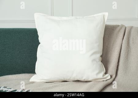 Blank soft pillow on cozy couch indoors Stock Photo