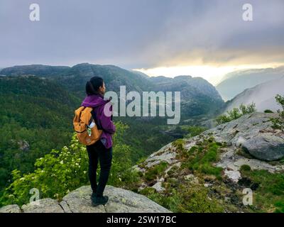 Contemplative Hiker Gazing at Majestic Norwegian Landscape at Dawn Stock Photo