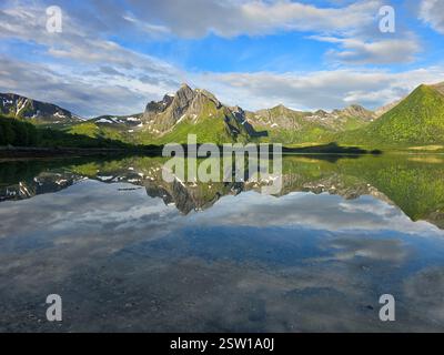 Lush Green Mountains Reflecting in Serene Lake Under a Beautiful Norwegian Sky Stock Photo