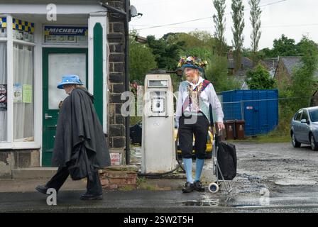 Couple argument UK. Morris man with shopping trolley and his wife, who is striding away after argument. Saddleworth Morris Man Bank Holiday weekend, Greenfield, Saddleworth Lancashire  2012, 2010s UK HOMER SYKES. Stock Photo