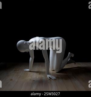 White fibreglass female mannequin in a tabletop position on a wooden floor. Stock Photo