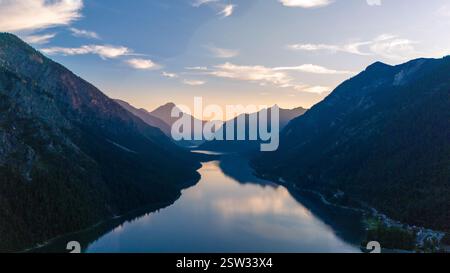Majestic sunrise over the tranquil waters of Plansee in Austria's breathtaking mountains Stock Photo