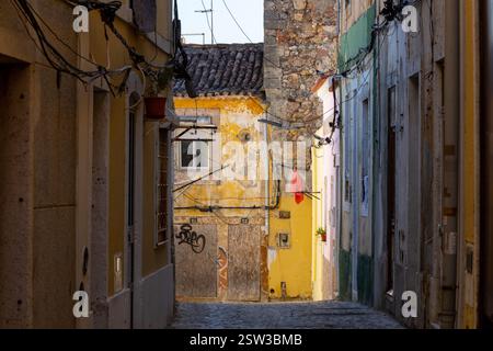 A typical old European street, narrow with its ancient buildings, European city. A cityscape of Setúbal with tiny shops and cafes. Stock Photo