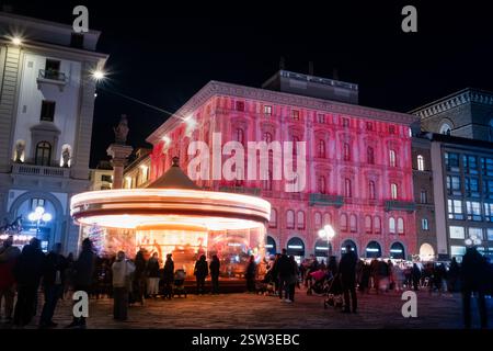 Night overview of the Republic square in Florence, Italy,. It is Christmas and there is a carousel in motion in the square. A shopping center has its Stock Photo
