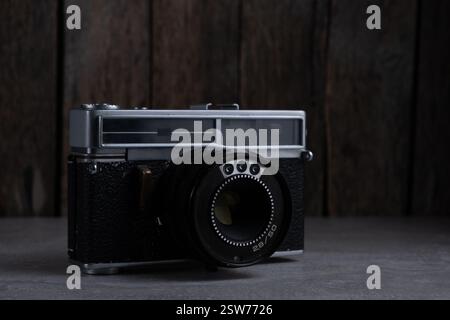 Old film camera on wooden background. Vintage style Stock Photo