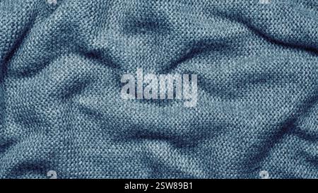 A soft and textured gray knitted fabric with gentle waves and folds, creating a cozy and warm appearance. Ideal for textile backgrounds, fashion, or Stock Photo