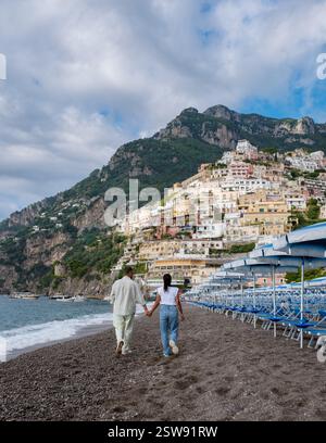 Strolling along the picturesque Amalfi Coast beach in Italy, hand in hand at a tranquil sunset Stock Photo