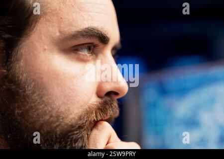 Focus on engineer using PC in blurry background to maintenance artificial intelligence neural networks. Remote IT employee doing checkup on AI systems, close up on face Stock Photo