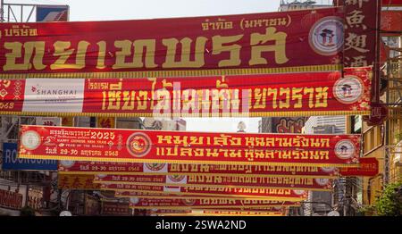 Bangkok, Thailand, January 2025, fabric banners in red and gold with Chinese script stretch across the street Stock Photo
