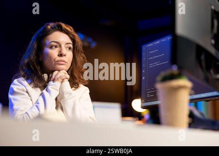 Pensive technician thinking how to design and develop software applications. Contemplative IT specialist brainstorming ways of implementing and maintaining company systems Stock Photo