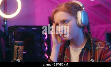 Caucasian woman girl unwell female teen gamer streamer influencer blogger coder programmer neon night overwork computer play video game typing online Stock Photo