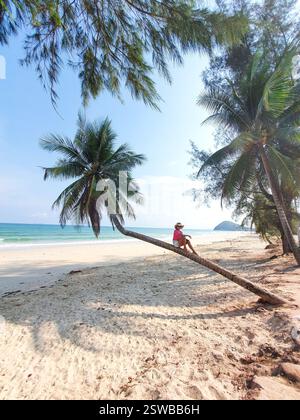 Relaxing on a Tropical Beach under Palm Trees on a Sunny Day in Chumphon Thailand Stock Photo