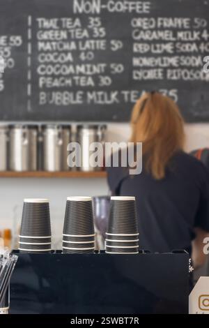 A counter of coffee shop with working female staff on a background Stock Photo