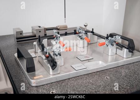 Precision Measurement Setup: Coordinate Measuring Machine inspecting a secured component ensuring accuracy Stock Photo