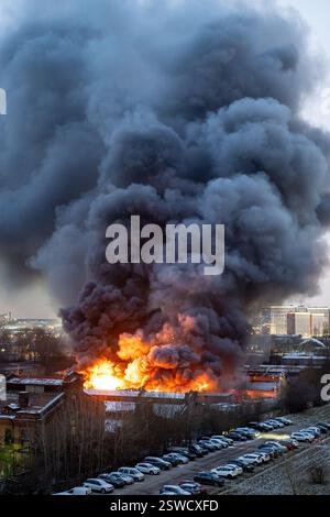 Heavy fire with acrid smoke in warehouse with toxic paint materials ...