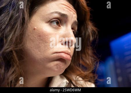 Unhappy woman sulking while doing software quality assurance, finding major errors in source code. Sad engineer upset after inspecting coding on desktop PC and seeing many issues Stock Photo