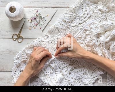 Sewing wedding dresses from Irish lace. Stock Photo
