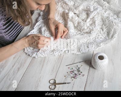 Sewing wedding dresses from Irish lace. Stock Photo