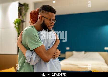 Loving supportive husband embracing his wife gently at home. Love and support in relationships Stock Photo