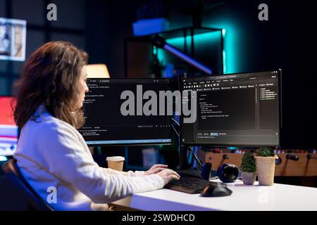 Freelancing computer scientist securing company servers from virus attacks to avoid unwanted failures. IT remote worker writing code to build firewalls protecting data from risks Stock Photo