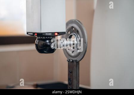 Precision measurement of a metal part using a coordinate measuring machine (CMM) in a quality control lab Stock Photo