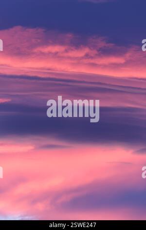 Soft pink and purple hues paint the evening sky creating a breathtaking sunset spectacle Stock Photo