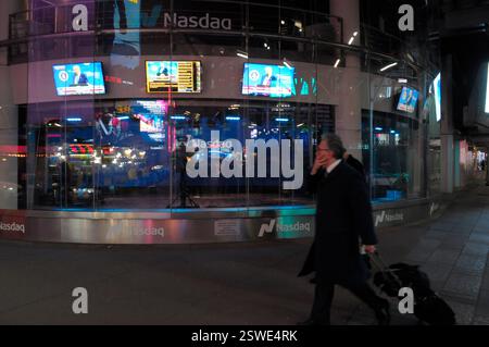 People walk past the Nasdaq MarketSite Times Square event space in ...