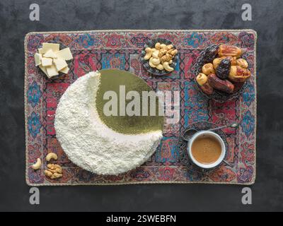 Delicious homemade cake in the shape of a Crescent moon, served with dates and coffee cup Stock Photo