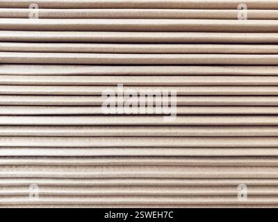 Side view of a corrugated cardboard. Cardboard boxes are folded on a pallet. Corrugated cardboard sheets are one by one. Stock Photo