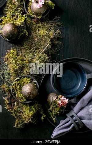 Easter table setting with empty black ceramic tableware Stock Photo